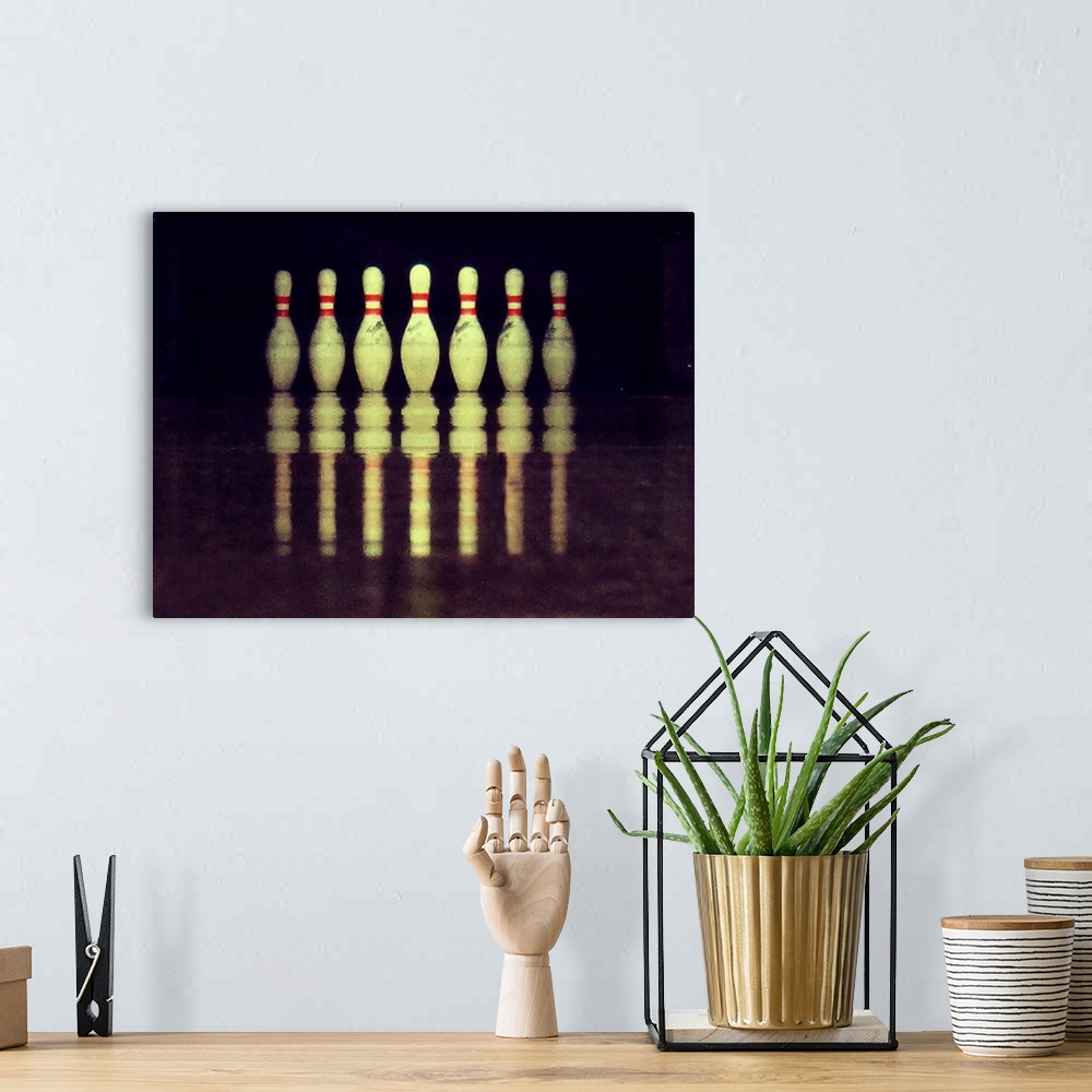 A bohemian room featuring Standing bowling pins with ground reflections.