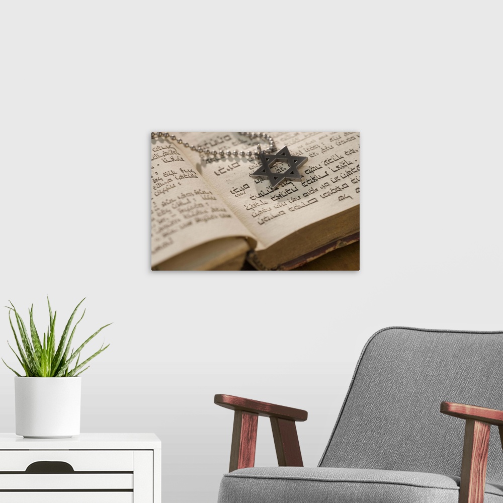 A modern room featuring Star of David necklace on book with Hebrew text