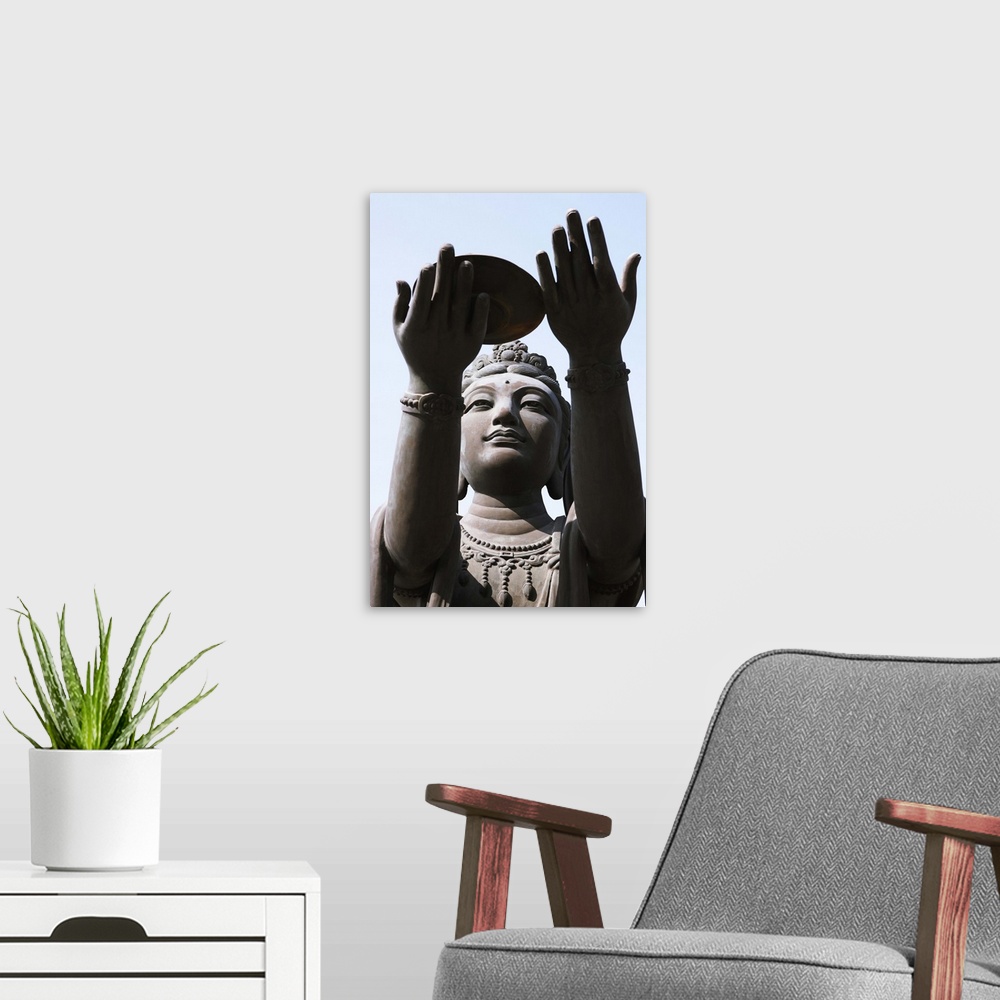 A modern room featuring Statue of Buddha against blue sky