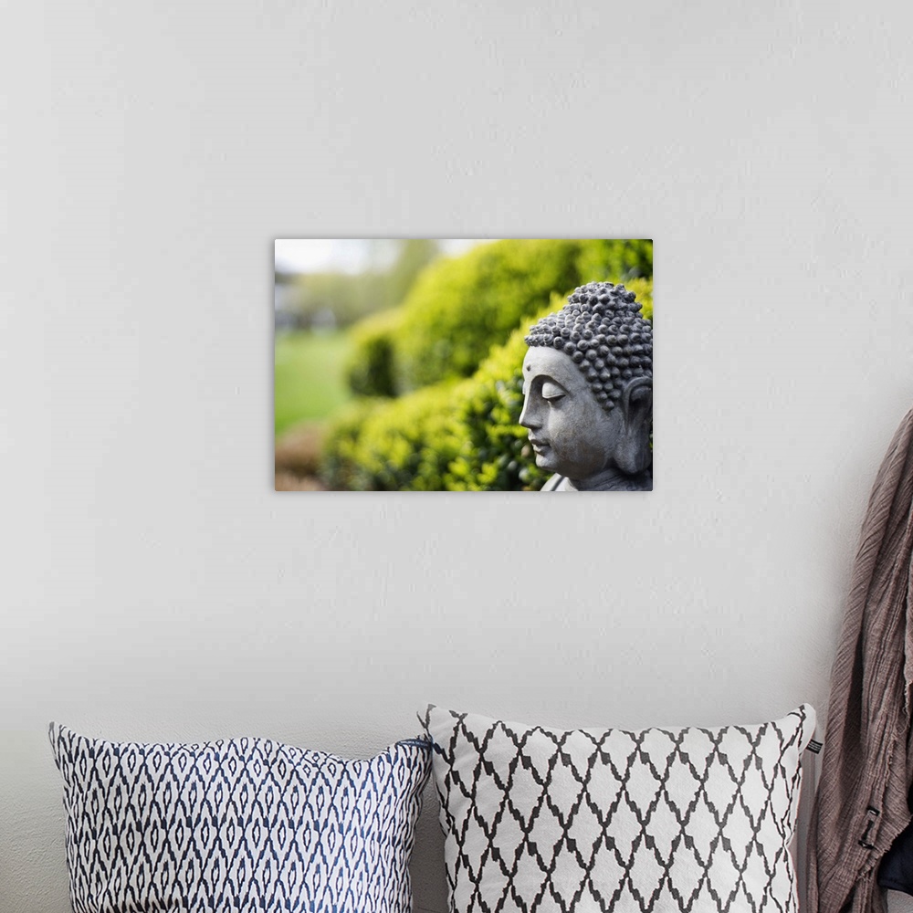 A bohemian room featuring Statue of Buddha in a garden