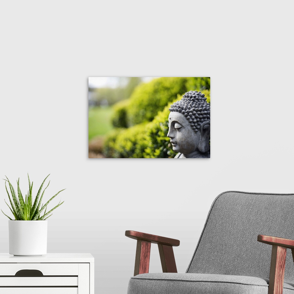 A modern room featuring Statue of Buddha in a garden