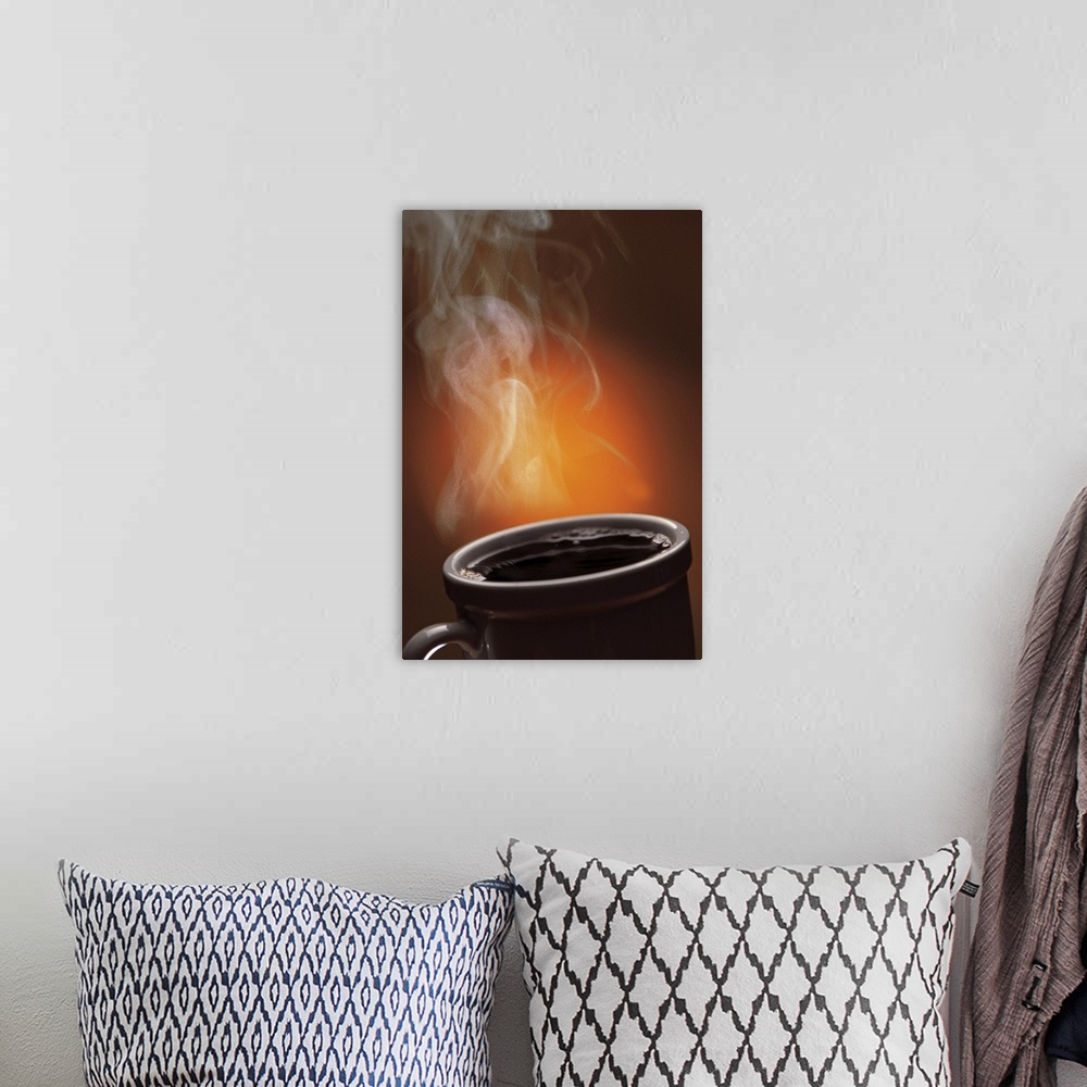 A bohemian room featuring This large vertical piece is a picture taken of a cup of black coffee with steam coming off of it.