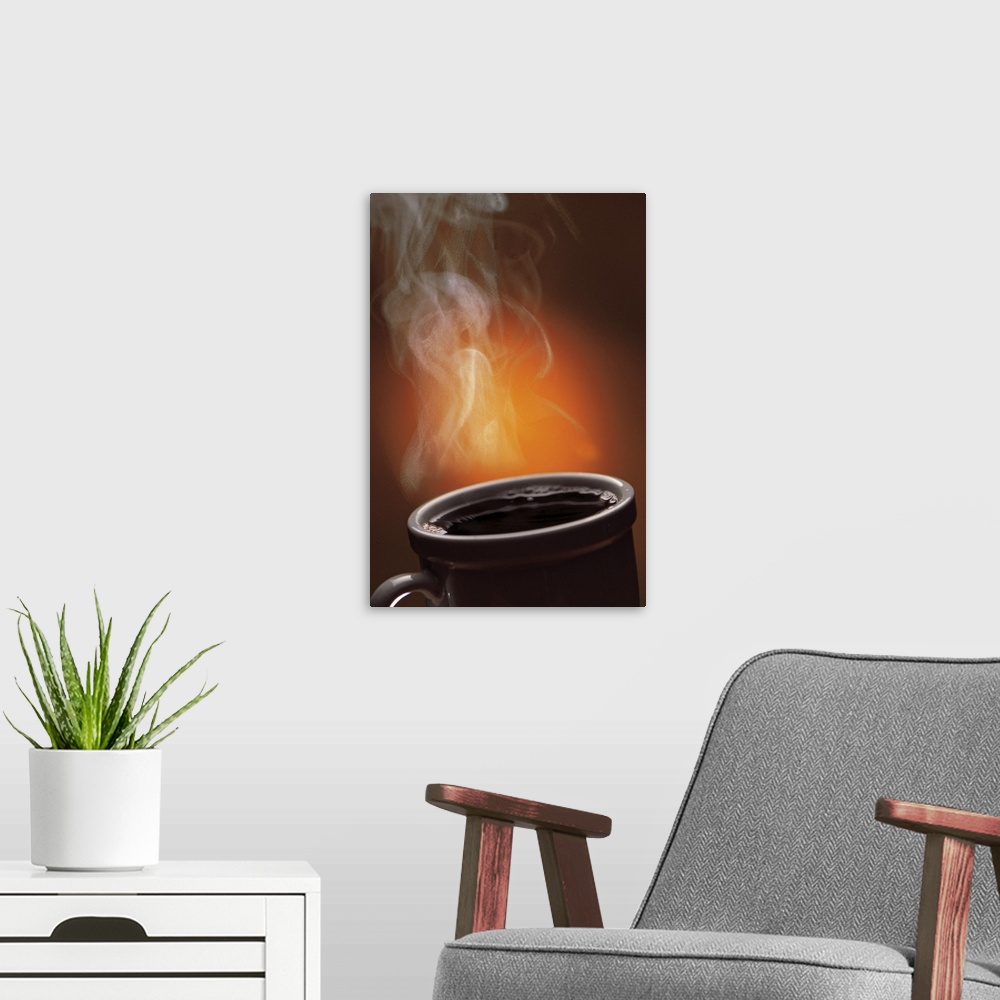 A modern room featuring This large vertical piece is a picture taken of a cup of black coffee with steam coming off of it.