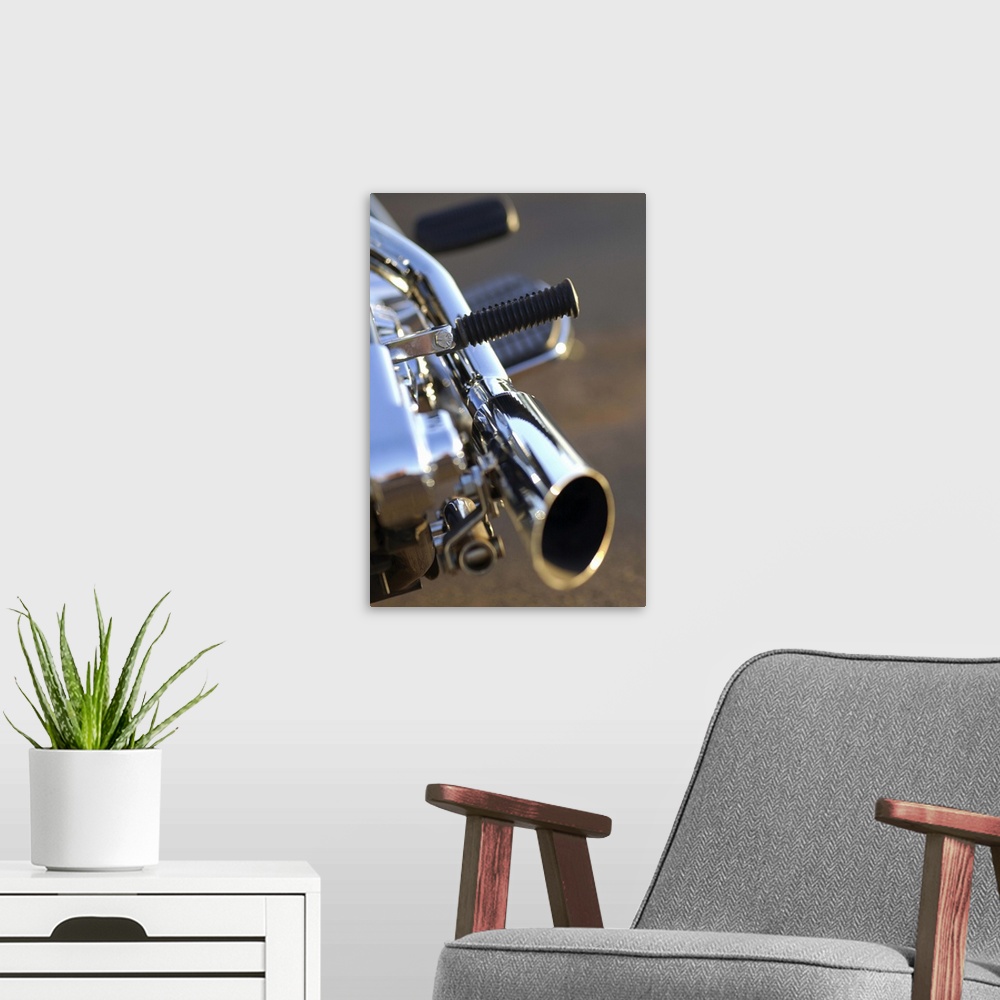 A modern room featuring Still-life close-up of a chrome tailpipe of a motorcycle