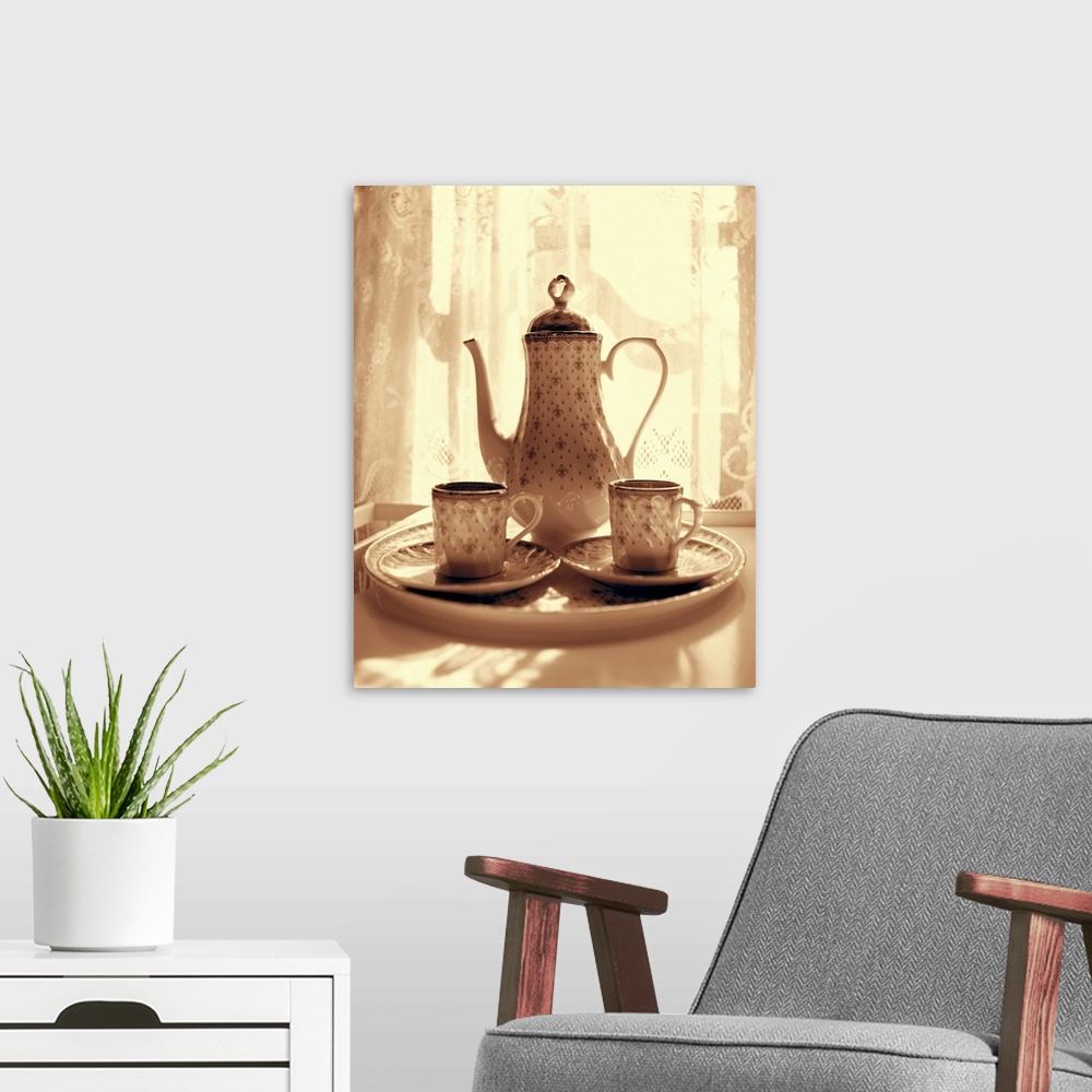 A modern room featuring Still life of teapot and cups on tray by window