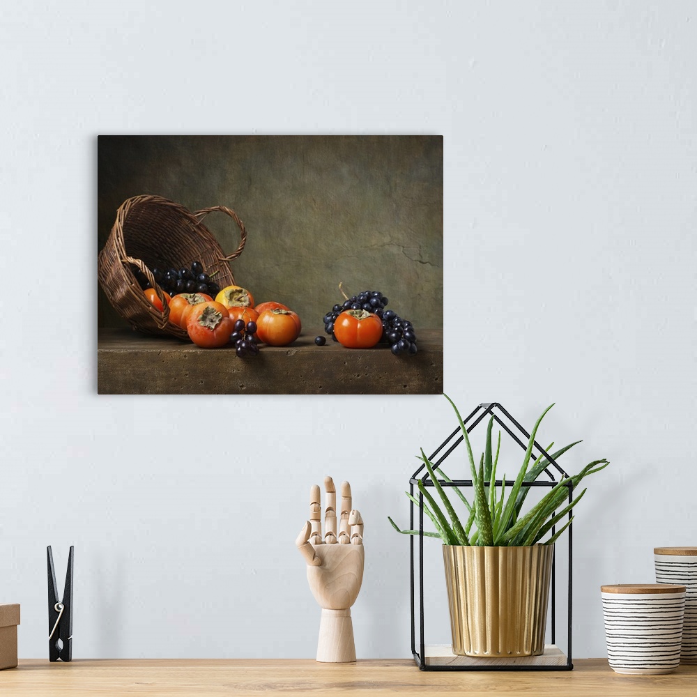A bohemian room featuring Still life with persimmons and grapes on the table.