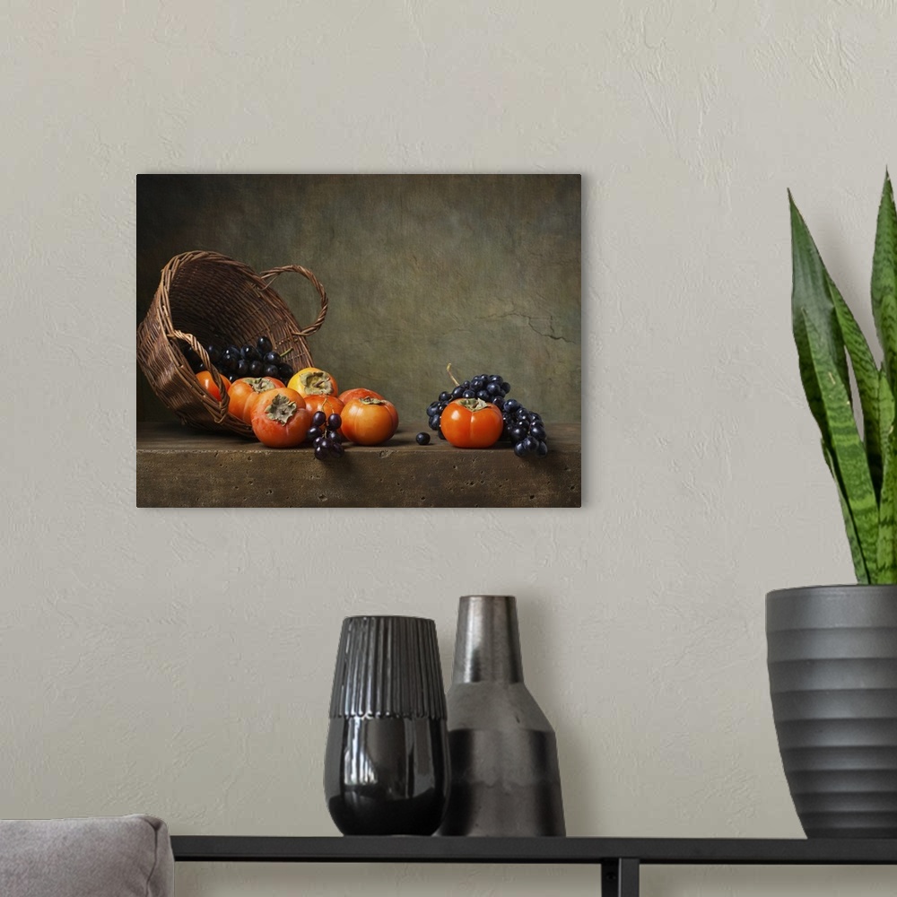A modern room featuring Still life with persimmons and grapes on the table.