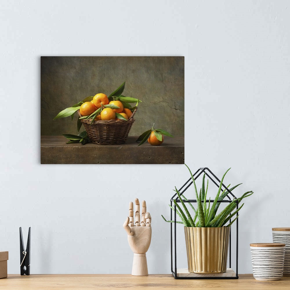 A bohemian room featuring Still life with tangerines in a basket on the table.