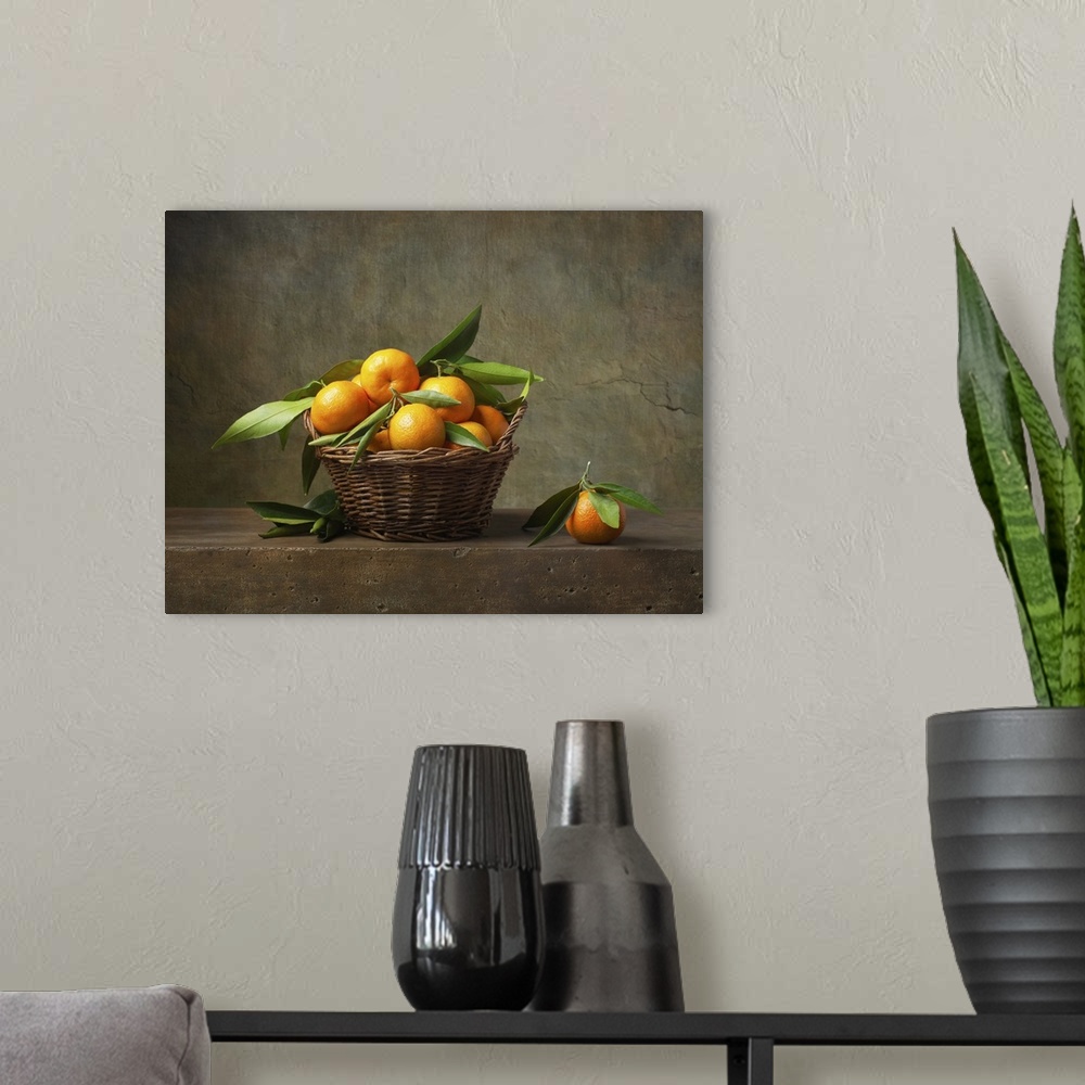 A modern room featuring Still life with tangerines in a basket on the table.