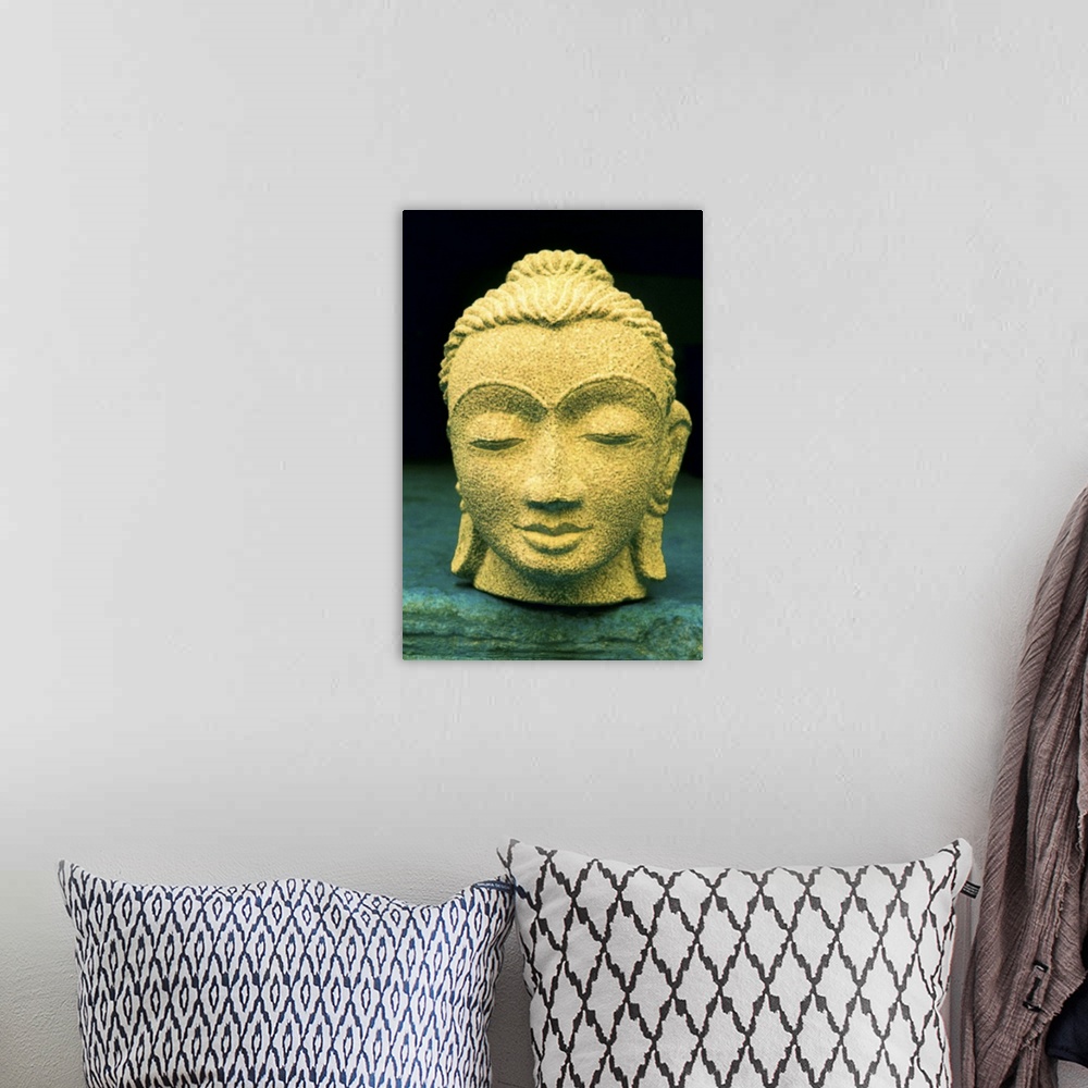 A bohemian room featuring Stone head of Buddha Gold