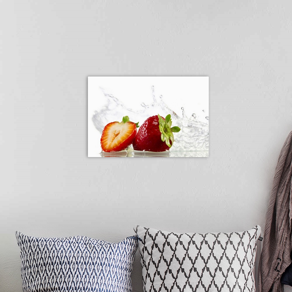 A bohemian room featuring Horizontal, photograph on large canvas of two strawberries, one cut in half, with water splashing...