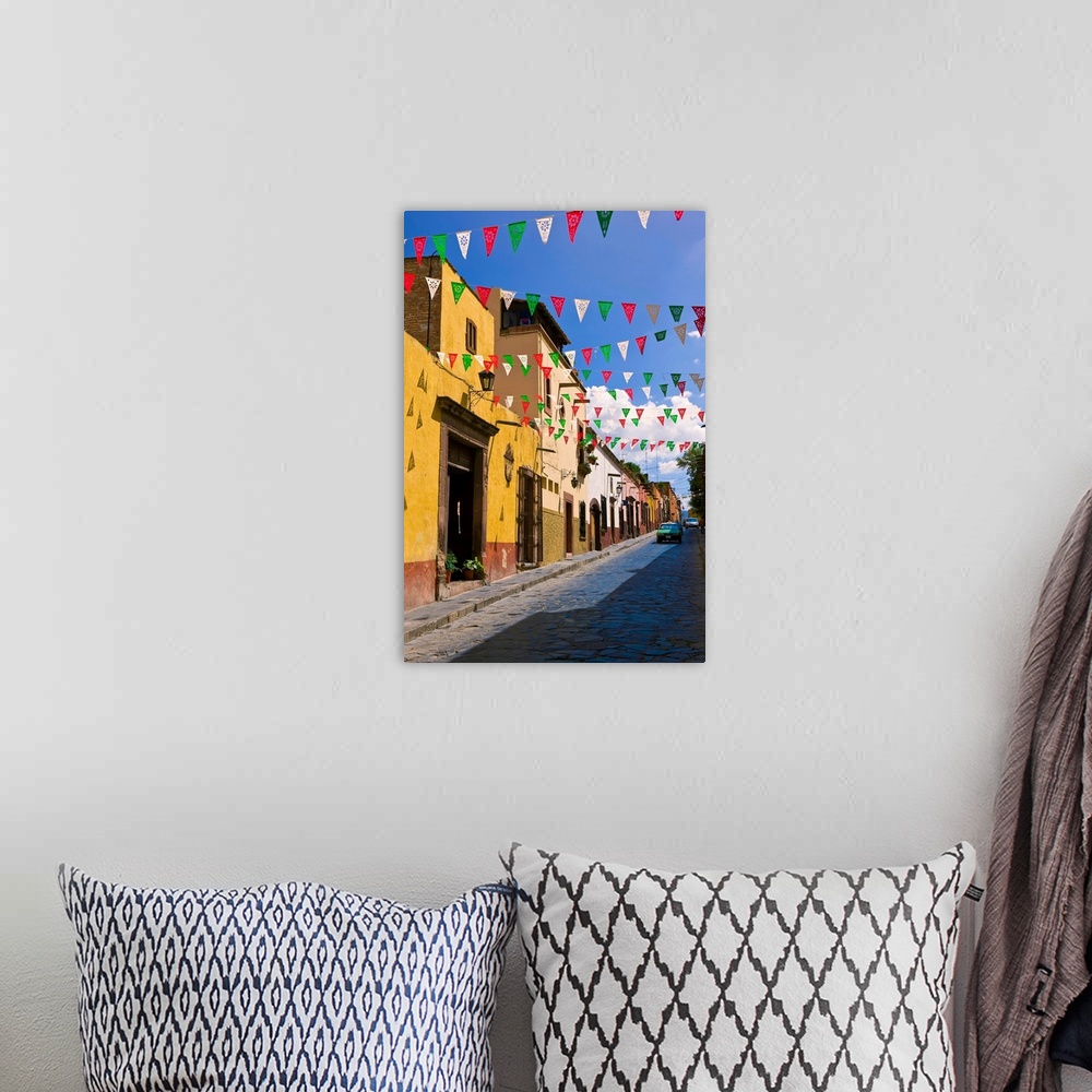A bohemian room featuring Street In San Miguel De Allende Decorated With Colorful Flags