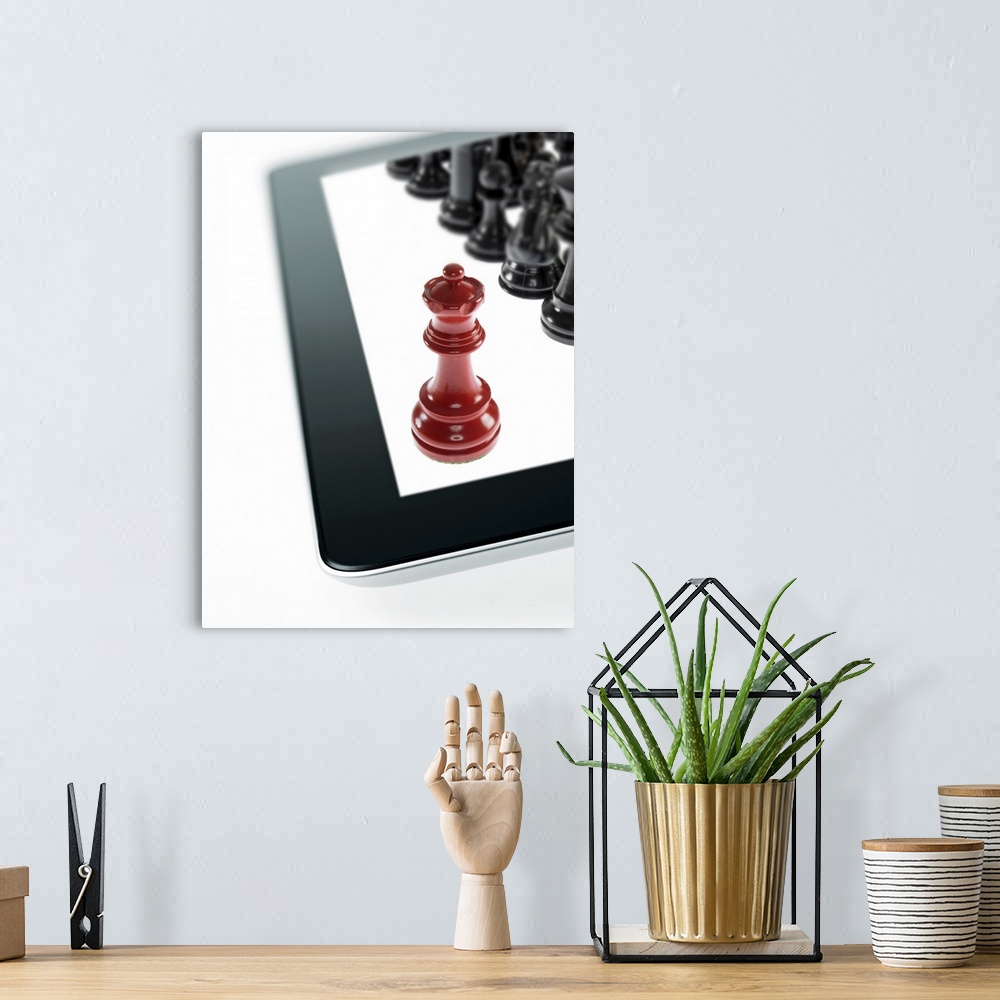A bohemian room featuring Studio shot of red chess queen and black chess pawns on tablet
