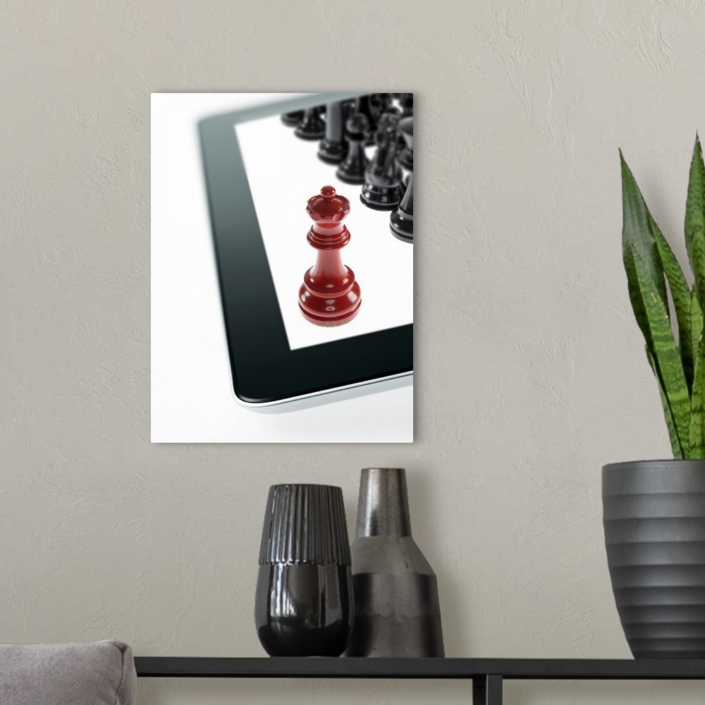 A modern room featuring Studio shot of red chess queen and black chess pawns on tablet
