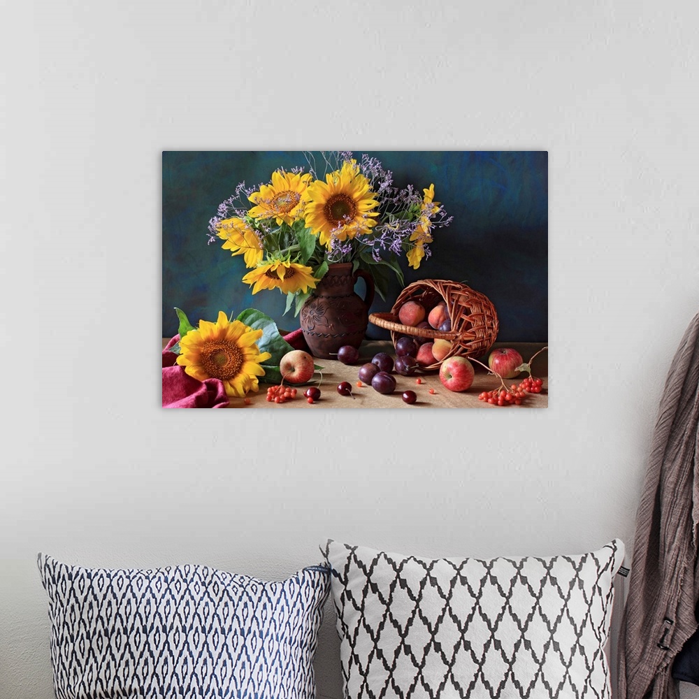 A bohemian room featuring Big photograph composed of a flower arrangement sitting within and around a ceramic jug that is n...