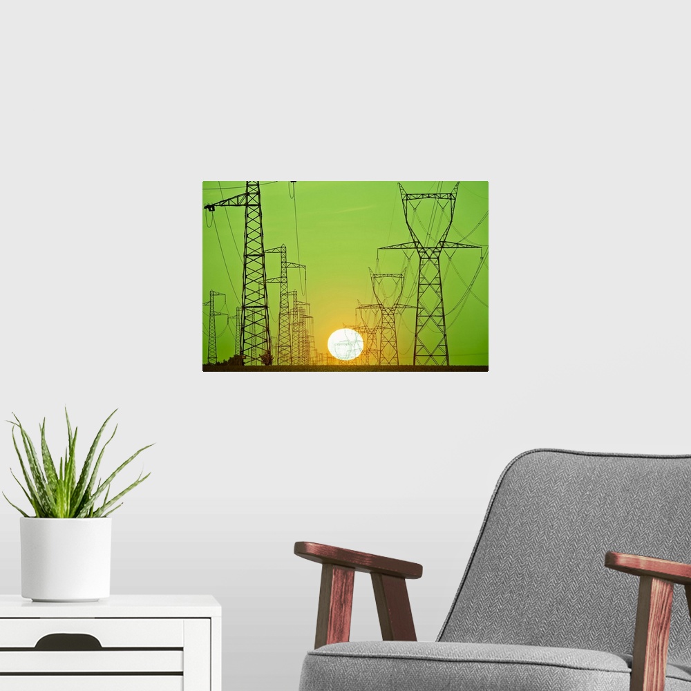 A modern room featuring Sun setting behind power lines