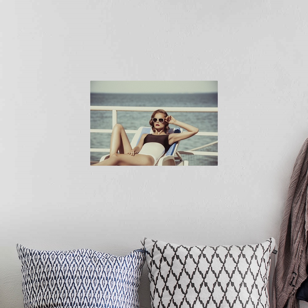 A bohemian room featuring Beautiful brown haired woman wearing bikini with sunglasses and elegant black and white swimsuit ...
