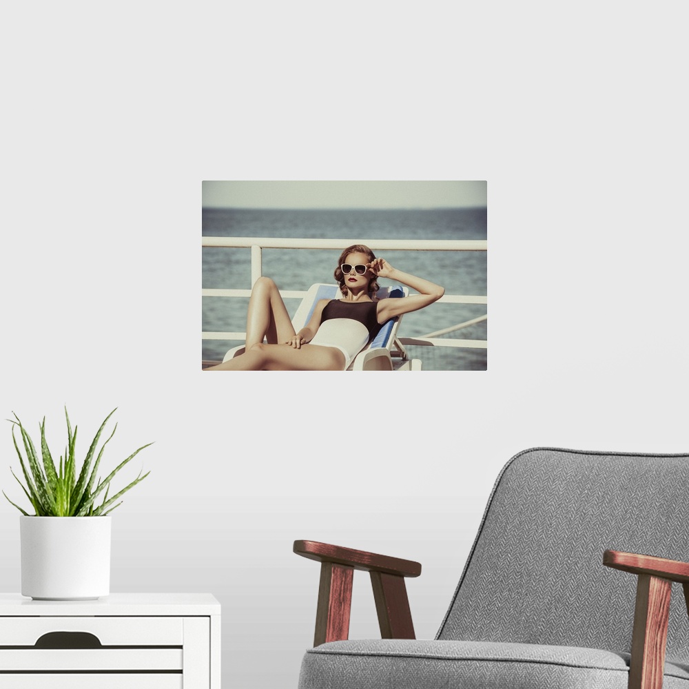 A modern room featuring Beautiful brown haired woman wearing bikini with sunglasses and elegant black and white swimsuit ...