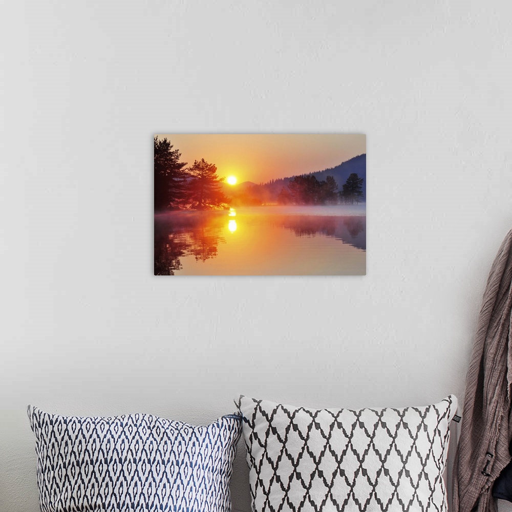 A bohemian room featuring Sunrise at mountain lake with island of pine trees.