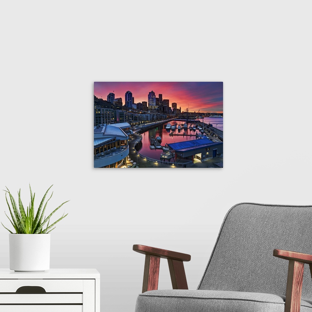 A modern room featuring Big canvas photo art of downtown Seattle meeting a harbor with a vibrant sunset in the distance.
