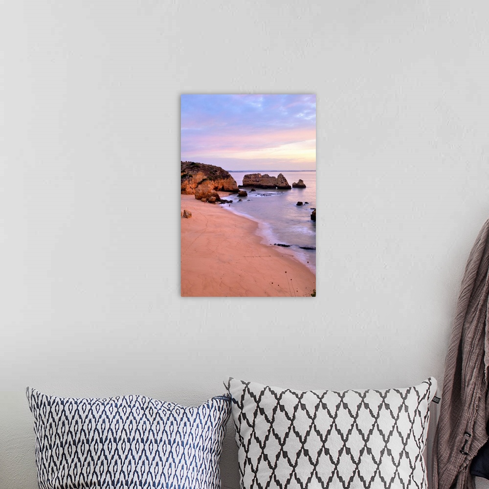A bohemian room featuring Sunrise at Praia Dona Ana Beach in Lagos, Portugal.pastel serene seascape coastline.