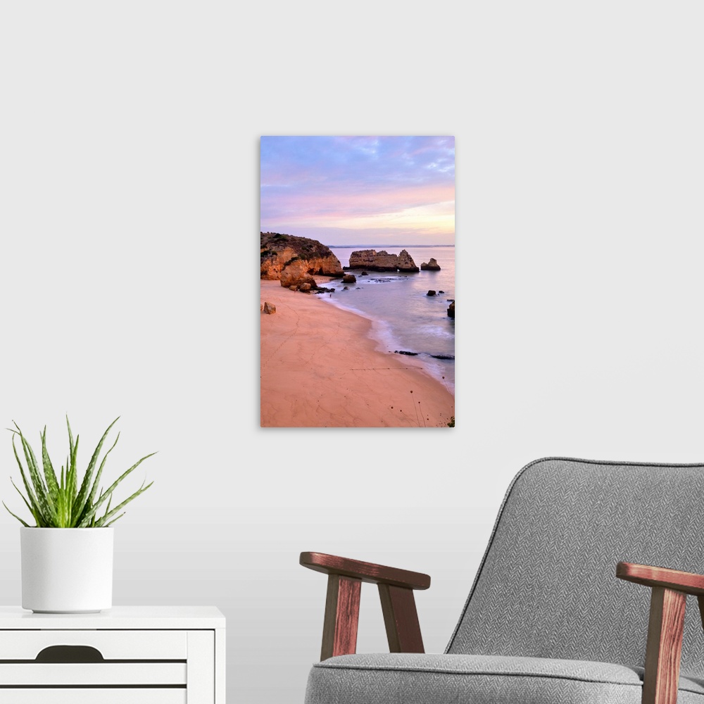 A modern room featuring Sunrise at Praia Dona Ana Beach in Lagos, Portugal.pastel serene seascape coastline.