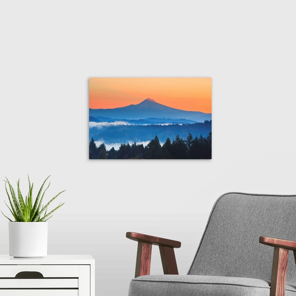 A modern room featuring sunrise thru morning fog adds beauty to Mt. Hood from Happy Valley, Oregon, Pacific Northwest.