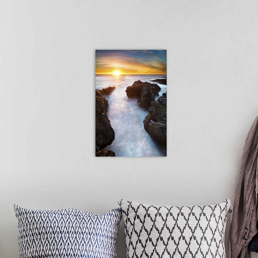 A bohemian room featuring Sunset at seashore with rocks and surf, US.