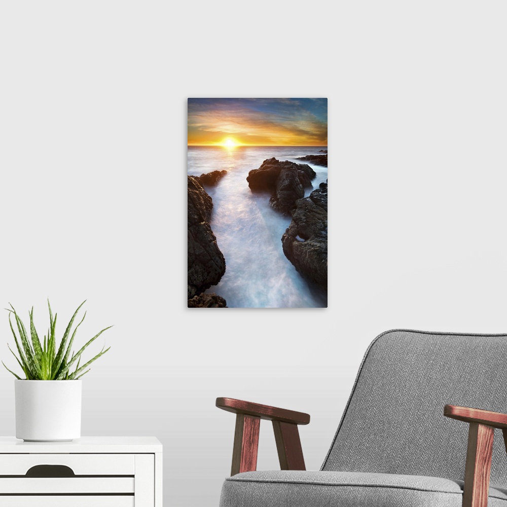 A modern room featuring Sunset at seashore with rocks and surf, US.