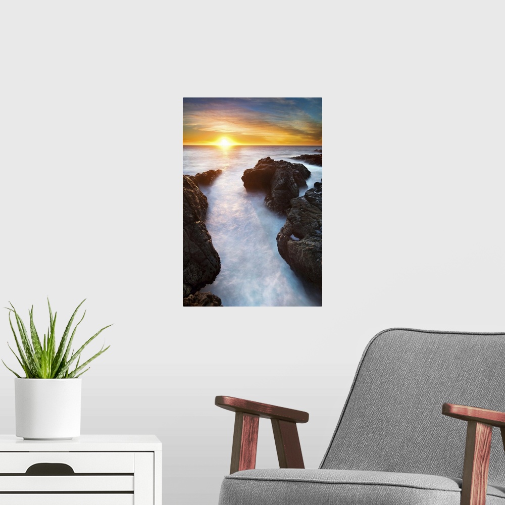 A modern room featuring Sunset at seashore with rocks and surf, US.