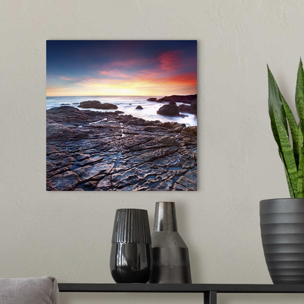 A modern room featuring California, sunset, ocean, beach, rocks, square.