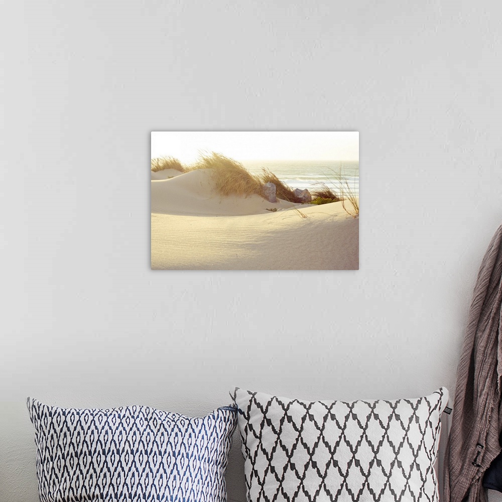 A bohemian room featuring Landscape photograph of grassy dunes beneath a setting sun, on a beach in Lisbon, Portugal, the w...