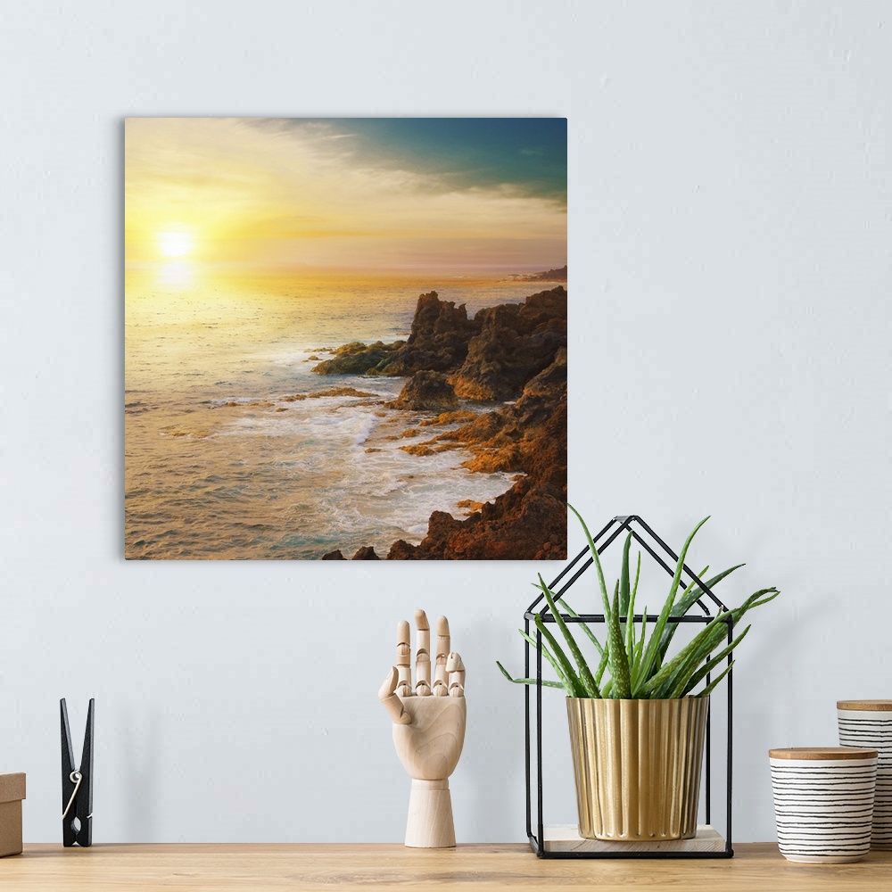 A bohemian room featuring The sun is about to set below the horizon and a photograph is taken overlooking the ocean from a ...