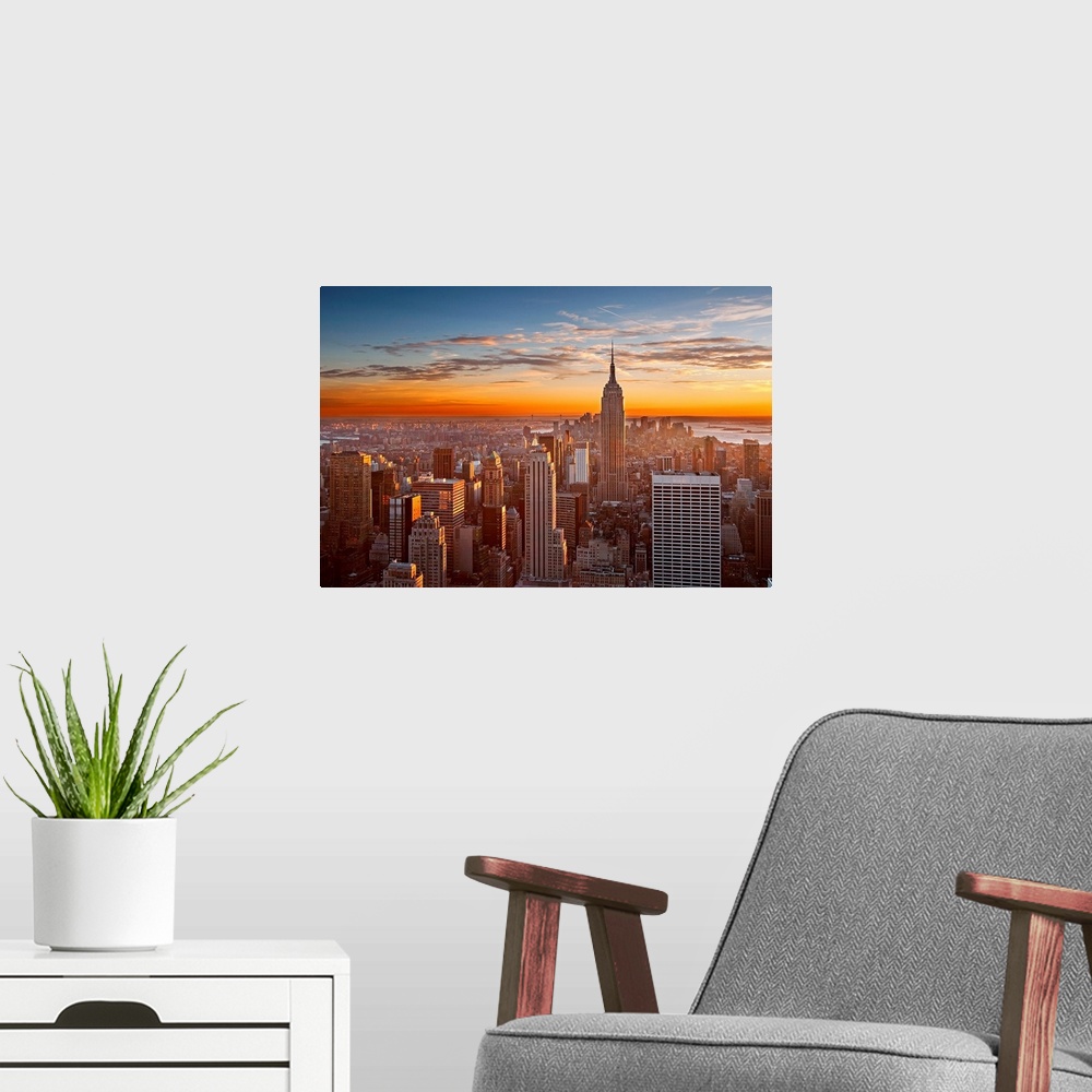 A modern room featuring Landscape orientation photograph of skyscrapers at the end of the day.