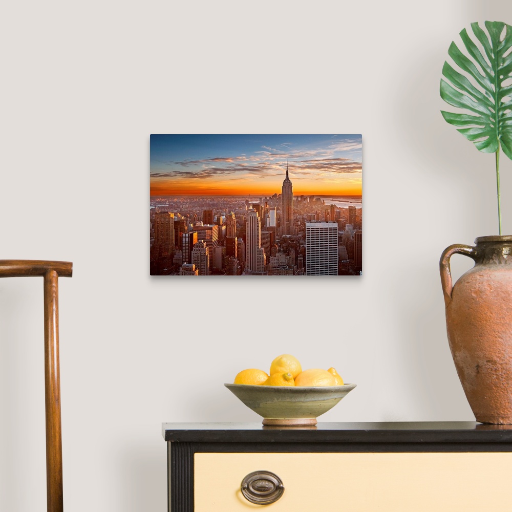 A traditional room featuring Landscape orientation photograph of skyscrapers at the end of the day.