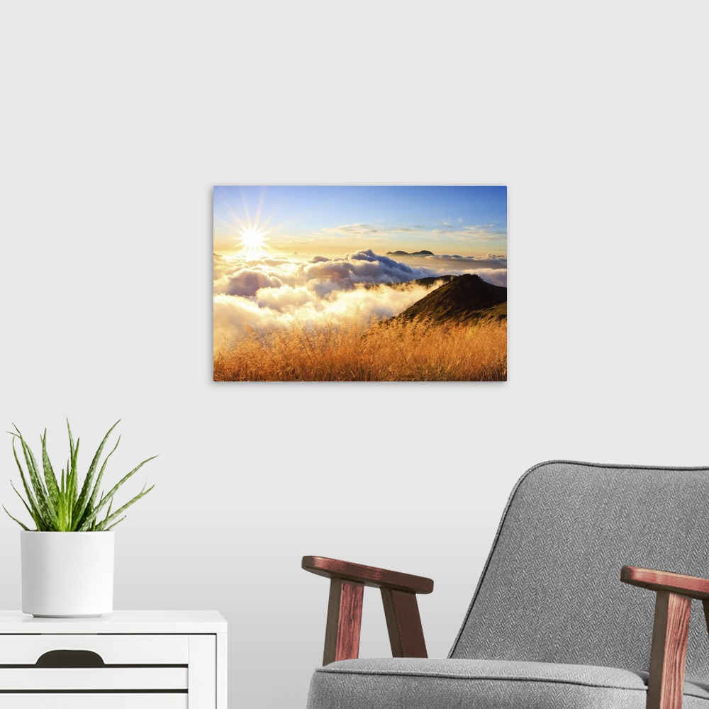 A modern room featuring Sunset over mountains with sea of clouds below.