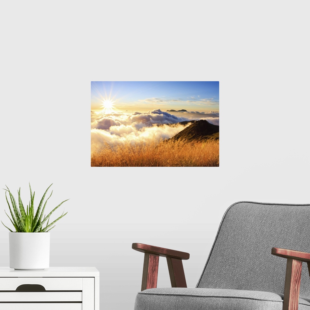 A modern room featuring Sunset over mountains with sea of clouds below.