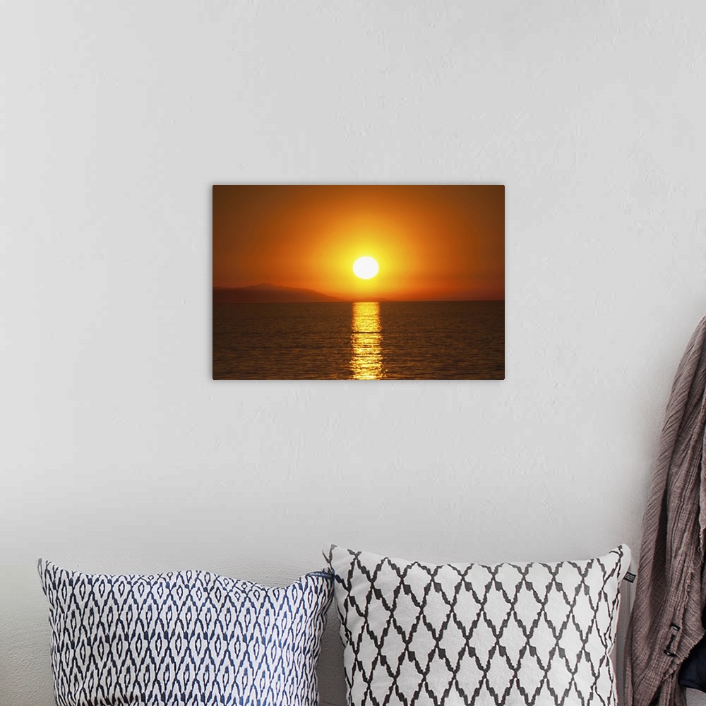 A bohemian room featuring Scenic dark orange sunset over Santa Catalina Island off the coast of California as seen from the...