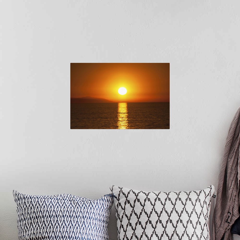 A bohemian room featuring Scenic dark orange sunset over Santa Catalina Island off the coast of California as seen from the...