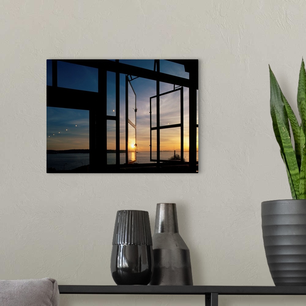 A modern room featuring A summer sunset is reflected on glass windows at Seattle's Pike Place Market.