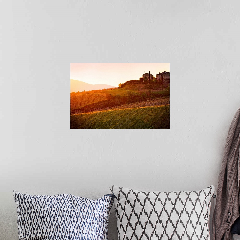 A bohemian room featuring The setting sun shines its last rays over a picturesque villa and its fields in this photo of Tus...