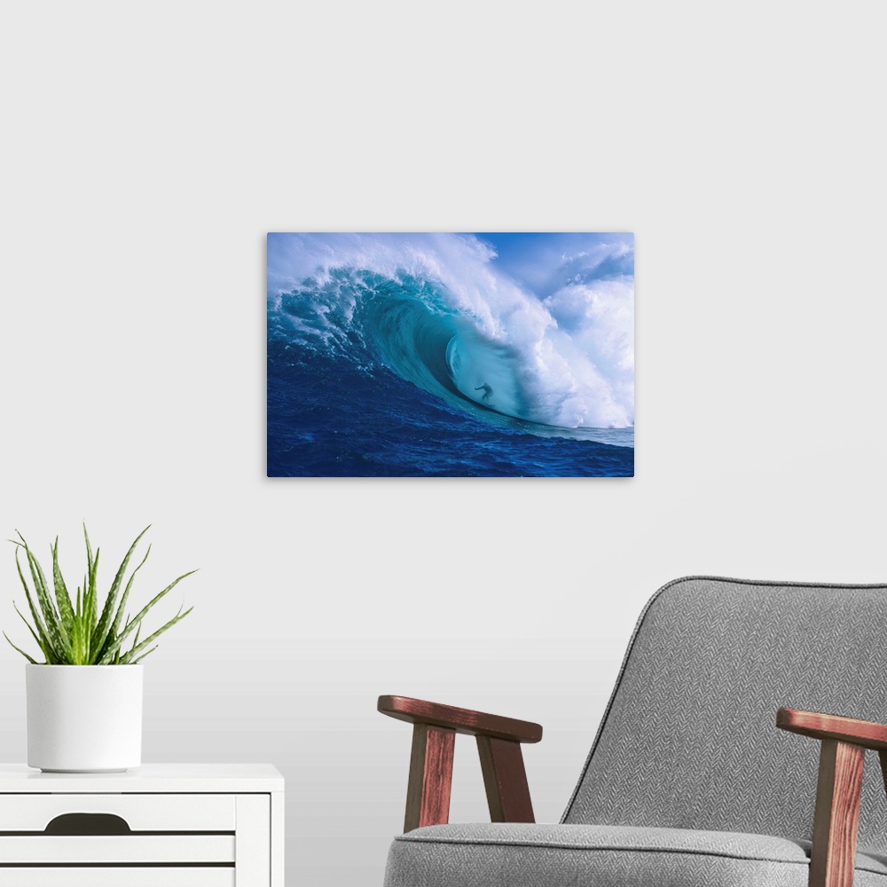 A modern room featuring Professional surfer Garrett McNamara shooting the curl of Jaws, an incredibly huge and powerful w...