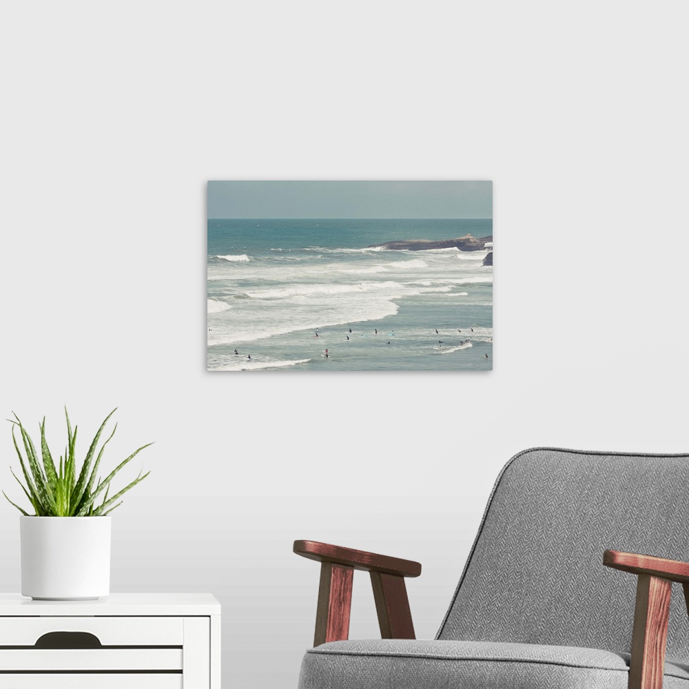 A modern room featuring Surfers lying in ocean.