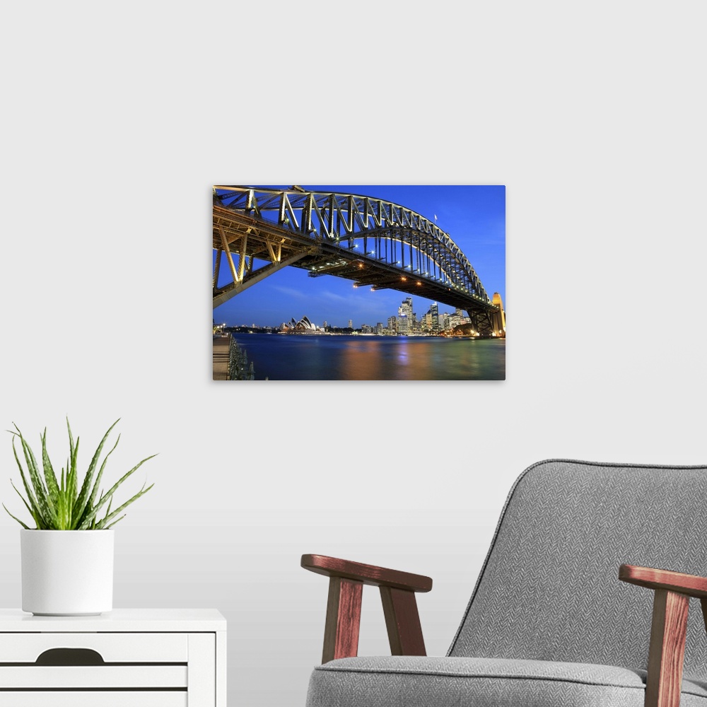 A modern room featuring Sydney Harbour Bridge, Sydney Opera House and city skyline at dusk
