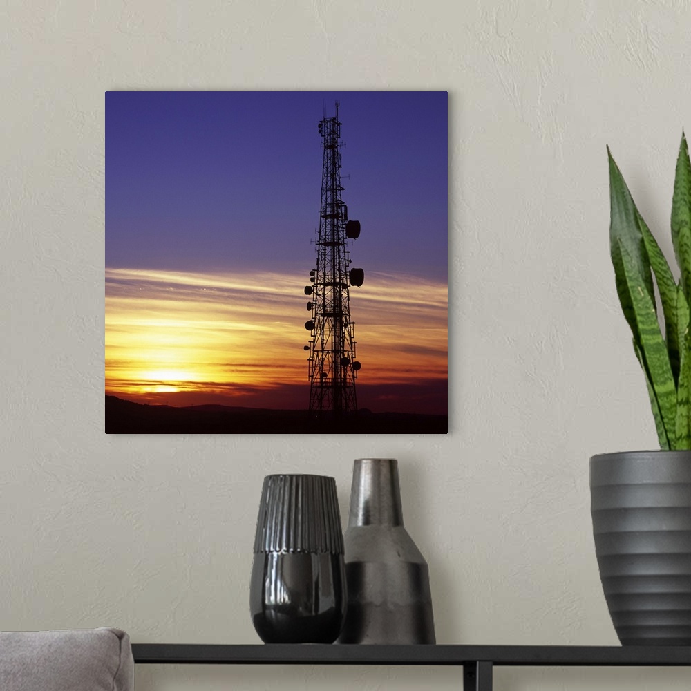 A modern room featuring Telecommunications mast at sunset