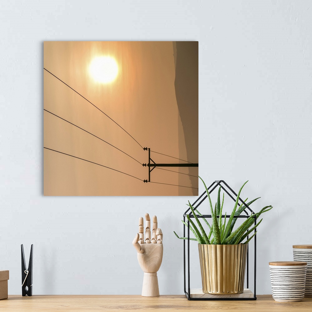 A bohemian room featuring Telephone wires and pole with sunset in background.
