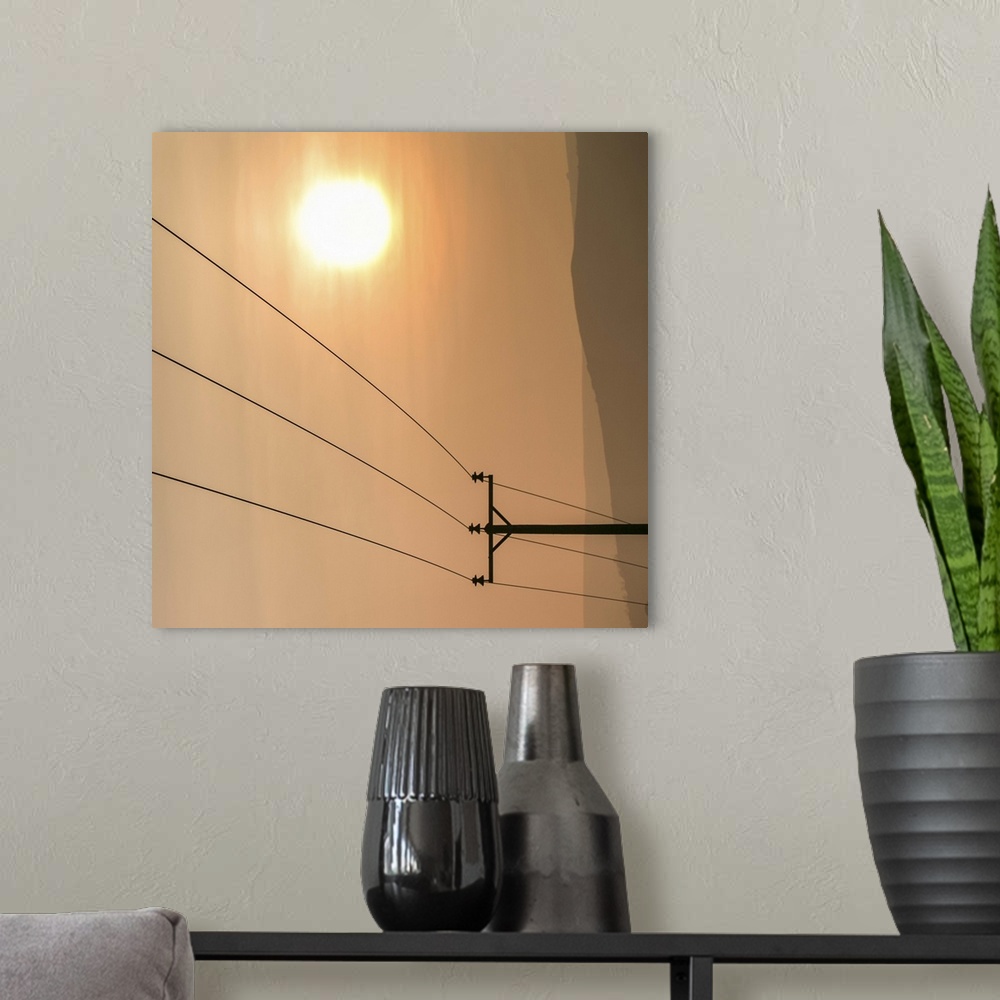 A modern room featuring Telephone wires and pole with sunset in background.