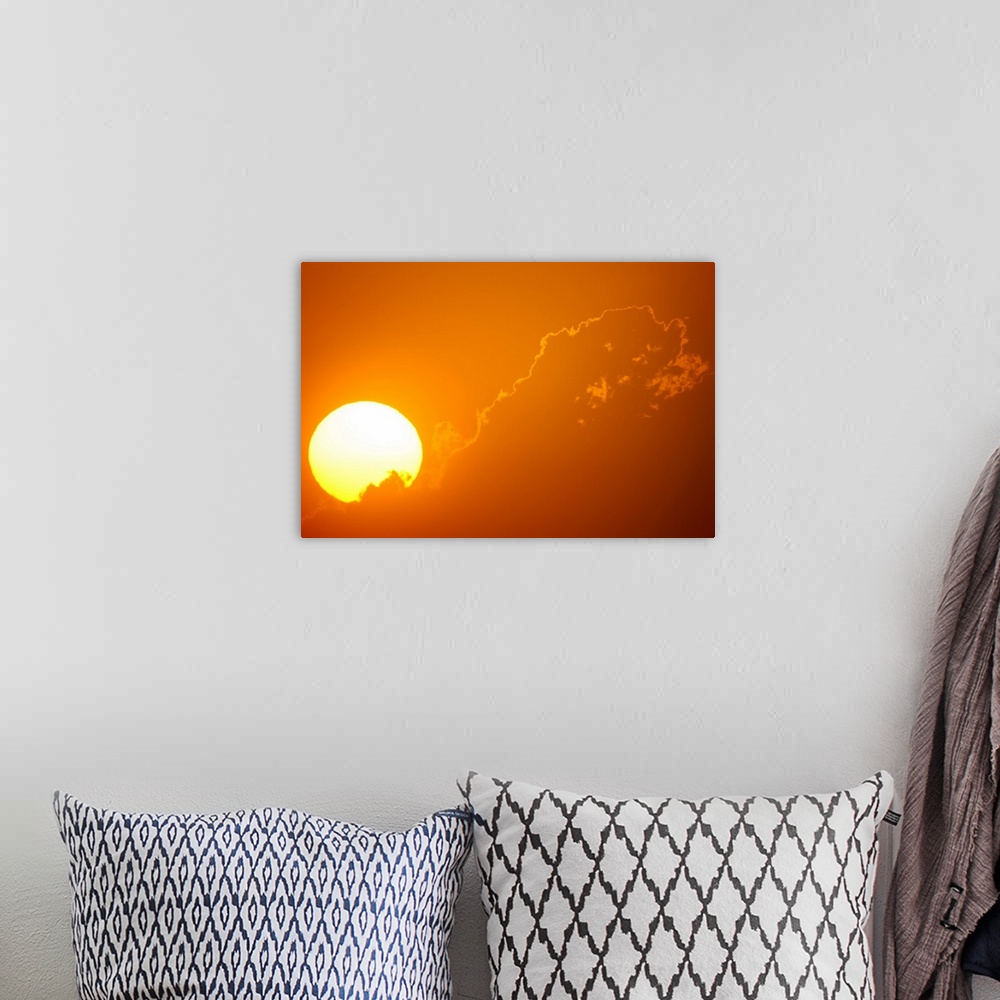 A bohemian room featuring Telephoto view of the rising sun behind orange clouds, Durban, Kwazulu-Natal, South Africa