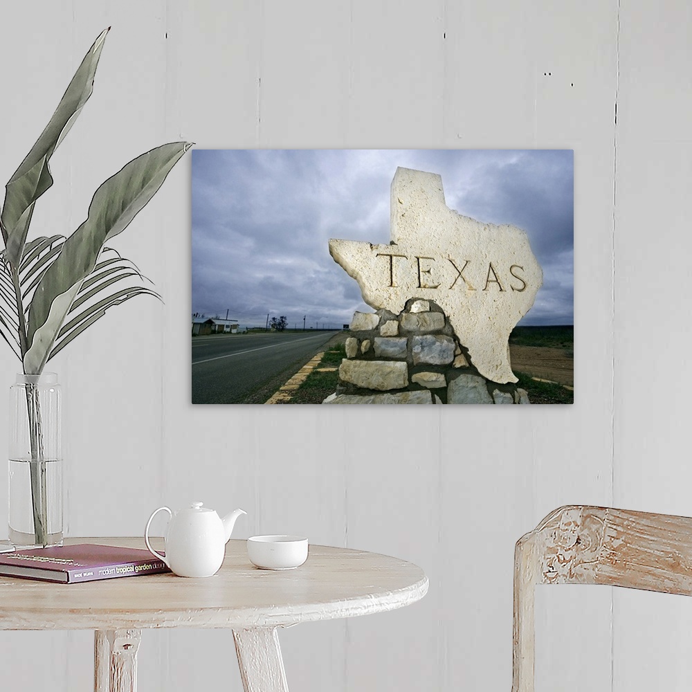 A farmhouse room featuring Photograph of a large stone placard in the shape of Texas welcoming visitors at the state border.