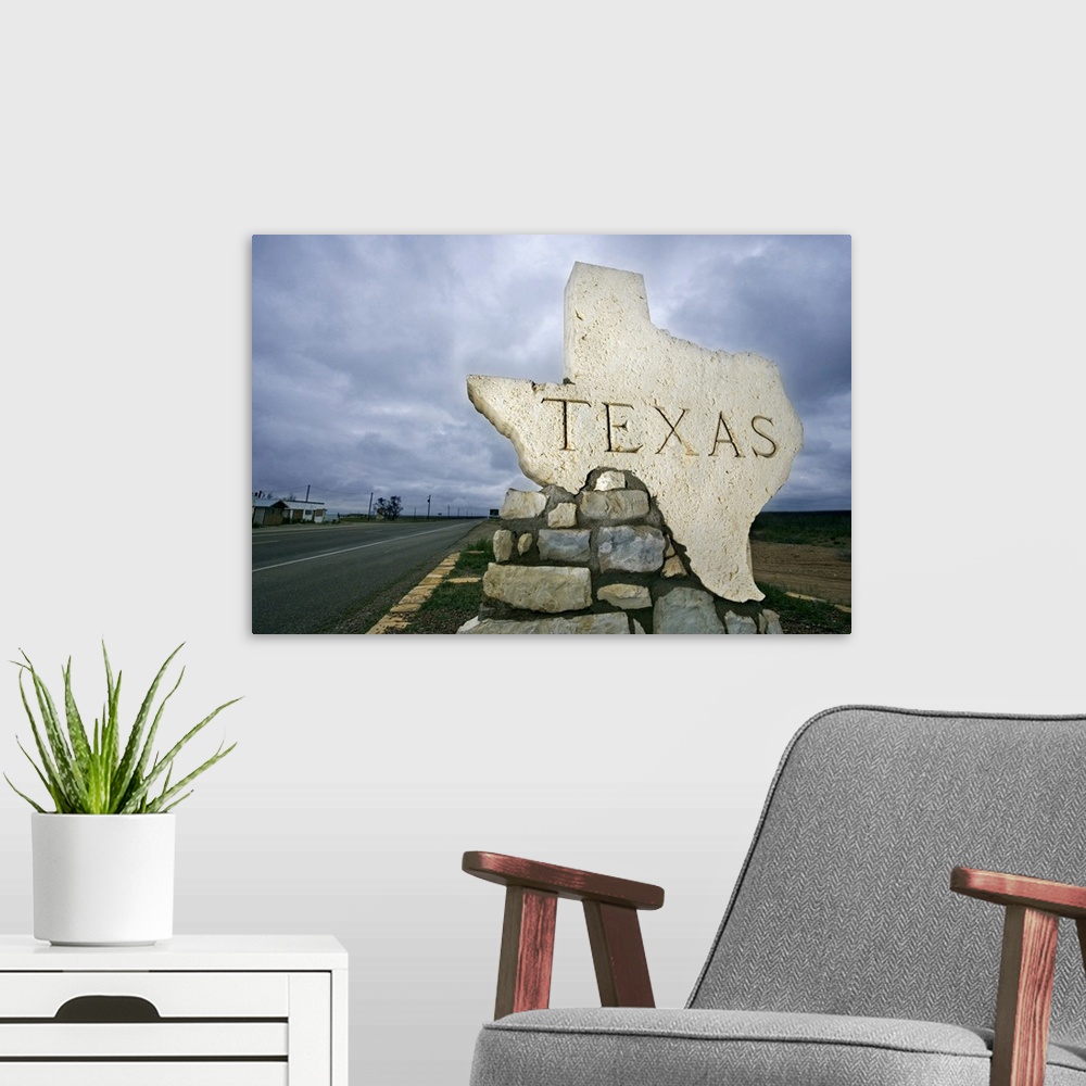 A modern room featuring Photograph of a large stone placard in the shape of Texas welcoming visitors at the state border.